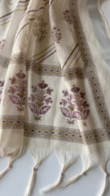 Elegant light cream mul linen unstitched salwar suit material featuring delicate pitta work and graceful all over prints. Perfect for sophisticated everyday and festive ethnic wear.